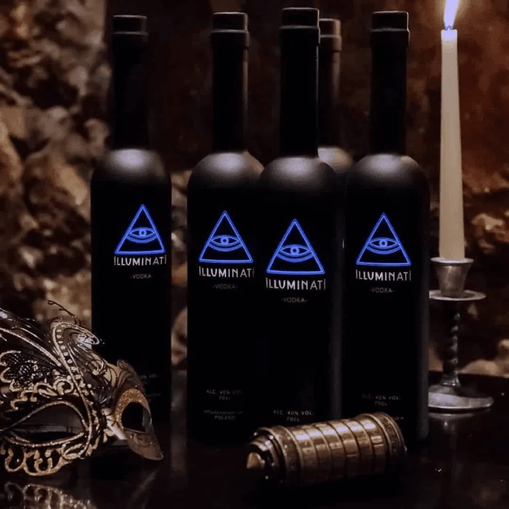 Four Illuminati Vodka bottles by candlelight with a decorative mask